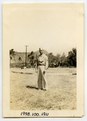 [Photograph of a Soldier Standing in front of Palm Trees]