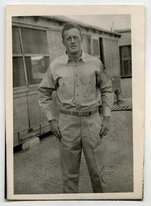 [Photograph of Harold Wells in Front of Hut]