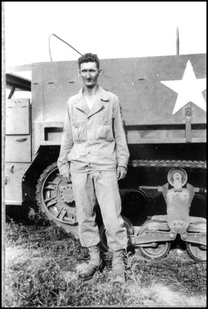 [Photograph of a Soldier and an Armored Truck]
