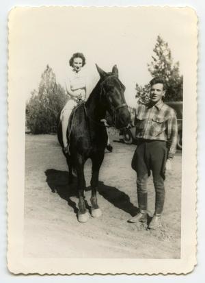 [Photograph of a Woman on a Horse and a Man]