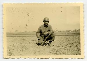 [Photograph of a Soldier Squatting with His Rifle]