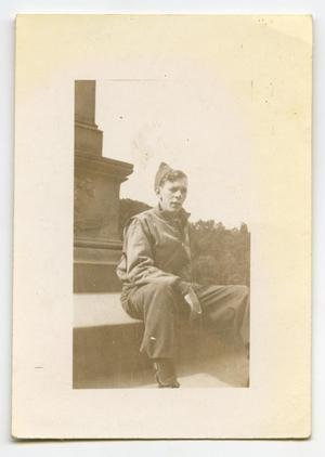 [A Soldier Sitting at the Base of a Monument]