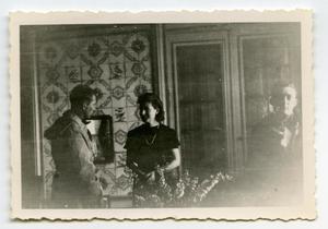 Primary view of object titled '[Photograph of Woman and Men Indoors]'.