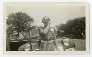 [Photograph of a Woman in front of a Car]