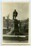 Photograph: [Photograph of Statue in Square of Damaged Buildings]
