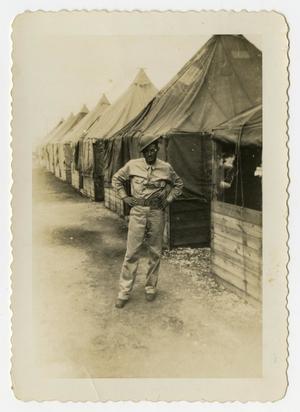 [Man With Tilted Helmet Near Tents]