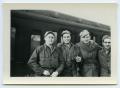 Photograph: [Four Soldiers Posing in Front of a Train]