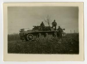 [Three Soldiers Stand on a German Tank]
