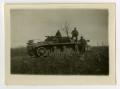 Photograph: [Three Soldiers Stand on a German Tank]
