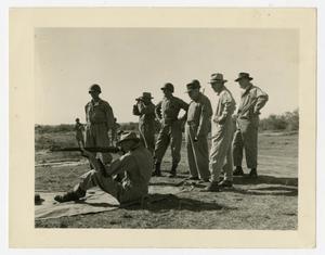Primary view of object titled '[Frank Grimes Shooting Rifle]'.