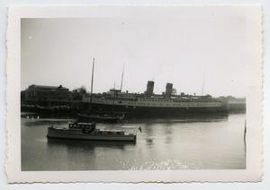[Photograph of a Large Ship by a Dock]