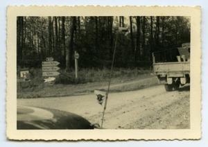 [Photograph of Vehicles on Dirt Road]
