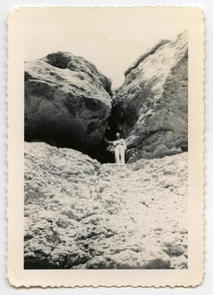 [Photograph of a Soldier in a Rock Crevice]