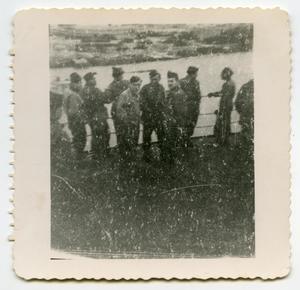 [A Group of Soldiers Standing Next to a Ship's Railing]