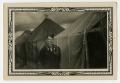 Photograph: [Man Standing Near Tents]