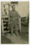 Primary view of [A Soldier Standing in Front of a Small Staircase]