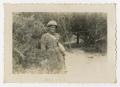 Photograph: [A Soldier Poses for a Picture Next to a Bush]