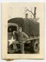 Photograph: [Photograph of Soldier by Army Truck]
