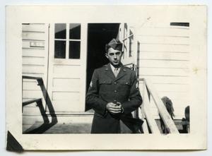 [Photograph of a Soldier at a Cabin]