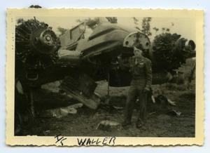 [Photograph of Soldier and Damaged Airplane]
