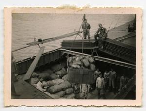 [Soldiers Oversee the Loading of Materials Onto a Barge]