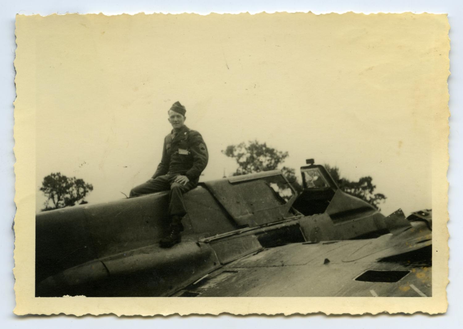 [Photograph of Soldier Sitting on Airplane]
                                                
                                                    [Sequence #]: 1 of 2
                                                