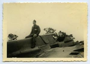 [Photograph of Soldier Sitting on Airplane]