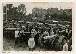 [Soldiers Standing Among Rows of 155 mm Cannons]