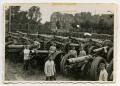 Photograph: [Soldiers Standing Among Rows of 155 mm Cannons]