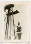 Photograph: [A Soldier Climbs Down From a Windmill]