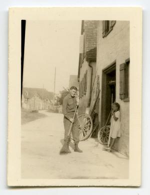 [Photograph of Soldier with Broom]