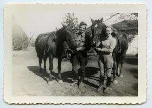 [Photograph of a Man and a Woman with Two Horses]