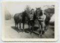 Photograph: [Photograph of a Man and a Woman with Two Horses]