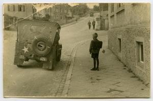 [Photograph of a Boy Next to a Jeep]