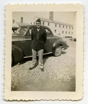 Primary view of object titled '[Photograph of a Soldier by an Automobile]'.