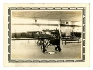 Primary view of object titled '[Photograph of an Old Airplane in a Cadet Classroom]'.