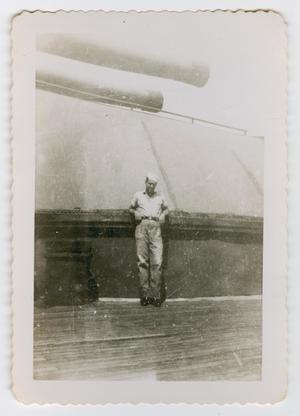 Primary view of object titled '[Photograph of Herman Stoner by the U.S.S. Texas' Guns]'.