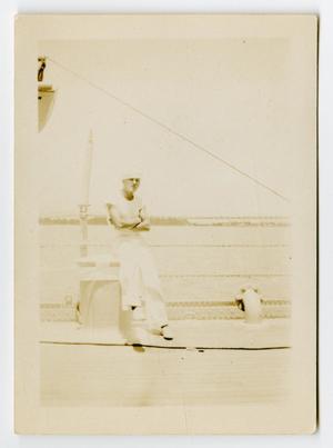 [Photograph of a Sailor on the Railing of the U.S.S. Texas]