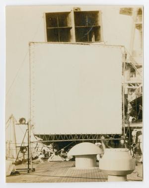 [Photograph of a Large Projector Screen on the Ship]