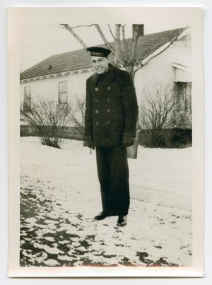 [Photograph of Norman J. Deichsel by a House]