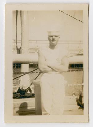 [Photograph of a Sailor Leaning on a Rail of the U.S.S. Texas]
