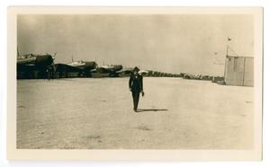 Primary view of object titled '[Man near Airplanes]'.
