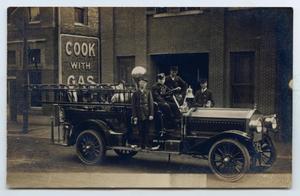 Primary view of object titled '[Photograph of a Firemen on a Fire Truck]'.