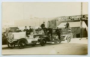 Primary view of object titled '[Postcard of a Long Fire Truck on a Street]'.
