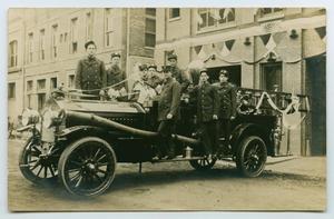 Primary view of object titled '[Photograph of a Fire Truck with Firemen]'.