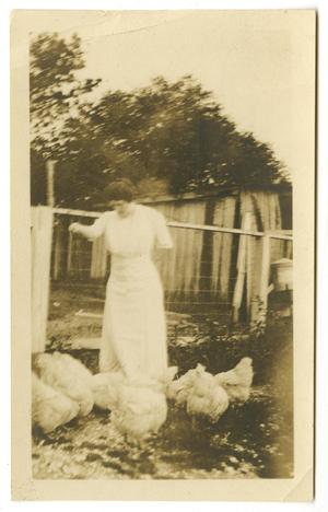 [Photograph of Ida Caldwell McFaddin Feeding Chickens]