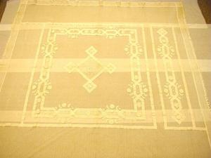 [White net coverlet with shirred applied scroll decoration]