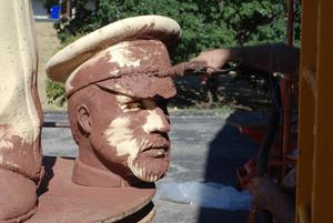 [Man Spray Painting Sculpture Head]