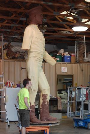 [Man Standing by a Sculpture]