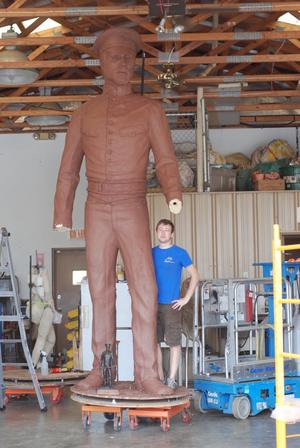 [Man Posing by Sculpture #2]